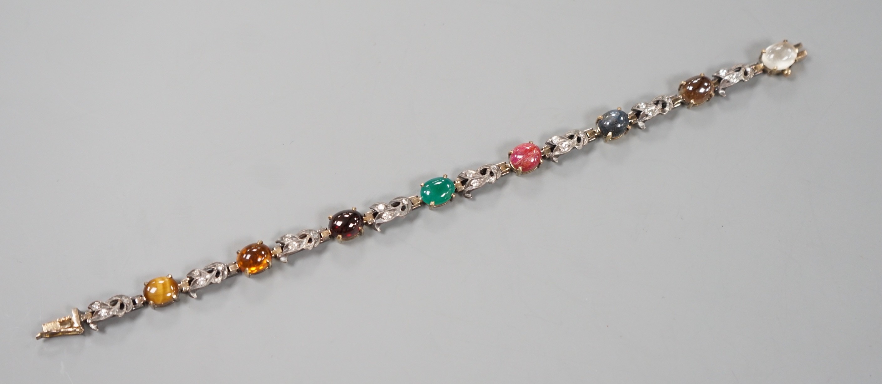 A yellow and white metal, multi cabochon gem and rose cut diamond set bracelet, 16.7cm, gross weight 11.9 grams.